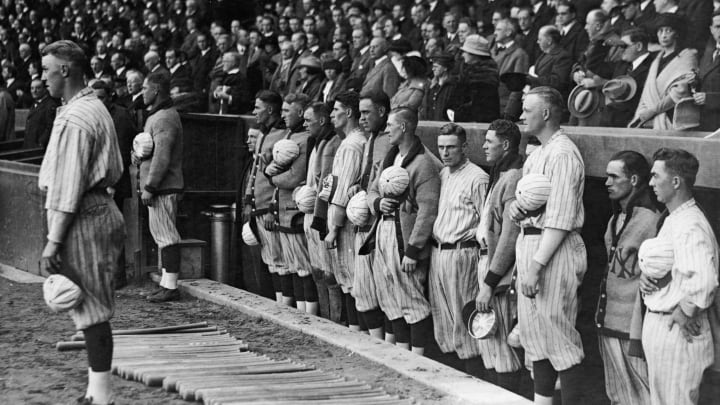 Members of the New York Yankees baseball team hold their caps over their hearts during a performance of the national anthem before the start of the eighth game of the World Series, New York, New York, October 13, 1921. The Yankees ended up losing both the game (0 – 1) and the series (3 – 5) to the New York Giants. (Photo by FPG/Getty Images)