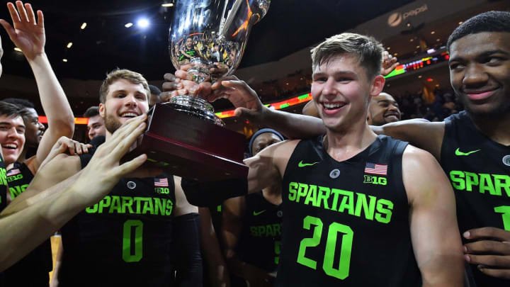 LAS VEGAS, NEVADA – NOVEMBER 23: Kyle Ahrens #0 and Matt McQuaid #20 of the Michigan State Spartans hold up the championship trophy after winning the championship game of the 2018 Continental Tire Las Vegas Invitational basketball tournament against the Texas Longhorns at the Orleans Arena on November 23, 2018 in Las Vegas, Nevada. Michigan State defeated Texas 78-68. (Photo by Sam Wasson/Getty Images)