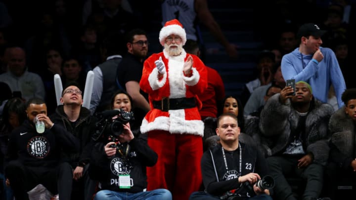 NEW YORK, NEW YORK - DECEMBER 08: A fan dressed as Santa Claus attends the game between the Brooklyn Nets and the Denver Nuggetsat Barclays Center on December 08, 2019 in New York City. Brooklyn Nets defeated the Denver Nuggets 105-102. NOTE TO USER: User expressly acknowledges and agrees that, by downloading and or using this photograph, User is consenting to the terms and conditions of the Getty Images License Agreement. (Photo by Mike Stobe/Getty Images)