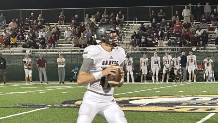 Benedictine's Luke Kromenhoek looks downfield before connecting with La'Don Bryant on a 42-yard Hail Mary touchdown pass to end the first half in a win over New Hampstead Thursday night.Kromenhoek