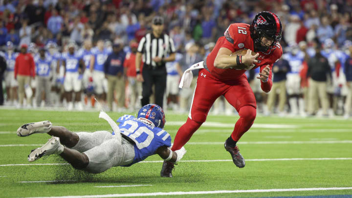 Dec 28, 2022; Houston, Texas, USA; Texas Tech Red Raiders quarterback Tyler Shough (12) runs with the ball and scores a touchdown as Mississippi Rebels cornerback Davison Igbinosun (20) defends during the first quarter in the 2022 Texas Bowl at NRG Stadium. Mandatory Credit: Troy Taormina-USA TODAY Sports