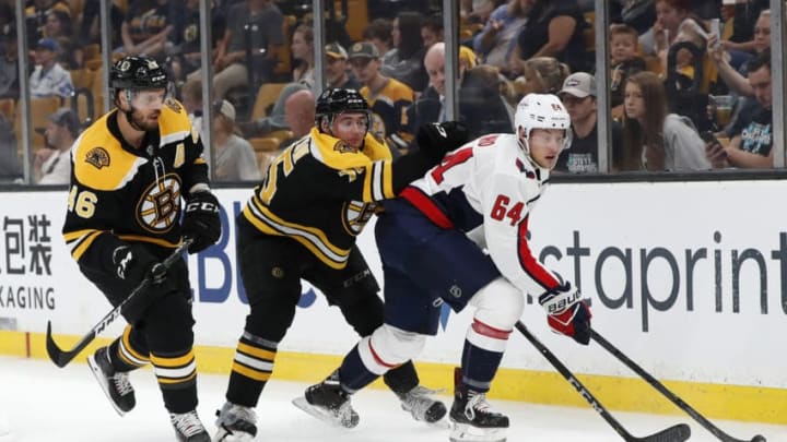 BOSTON, MA - SEPTEMBER 16: Washington Capitals forward Brian Pinho (64) pressure by Boston Bruins defenseman Connor Clifton (75) and Boston Bruins center David Krejci (46) during a preseason game on September 16, 2018, between the Boston Bruins and the Washington Capitals at TD Garden in Boston, Massachusetts. The Bruins defeated the Capitals 2-1 (SO). (Photo by Fred Kfoury III/Icon Sportswire via Getty Images)
