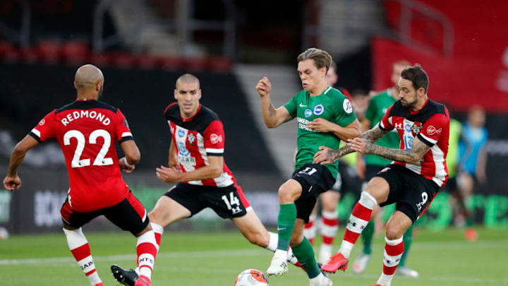 SOUTHAMPTON, ENGLAND - JULY 16: Leandro Trossard of Brighton takes on Nathan Redmond and Danny Ings during the Premier League match between Southampton FC and Brighton & Hove Albion at St Mary's Stadium on July 16, 2020 in Southampton, England. Football Stadiums around Europe remain empty due to the Coronavirus Pandemic as Government social distancing laws prohibit fans inside venues resulting in all fixtures being played behind closed doors. (Photo by Frank Augstein/Pool via Getty Images)