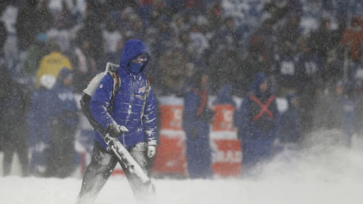 Dec 10, 2017; Orchard Park, NY, USA; A Buffalo Bills grounds keeper clears snow off the field during a stoppage in play against the Indianapolis Colts during the second half at New Era Field. Buffalo defeated Indianapolis 13-7 in overtime. Mandatory Credit: Timothy T. Ludwig-USA TODAY Sports