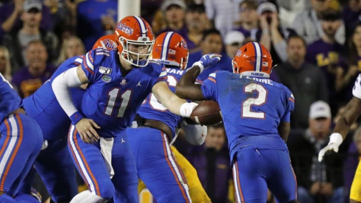 BATON ROUGE, LA - OCTOBER 12: Florida Gators quarterback Kyle Trask (11) hands off to running back Lamical Perine (2) against LSU Tigers on October 12, 2019 at the Tiger Stadium in Baton Rouge, LA. (Photo by Stephen Lew/Icon Sportswire via Getty Images)