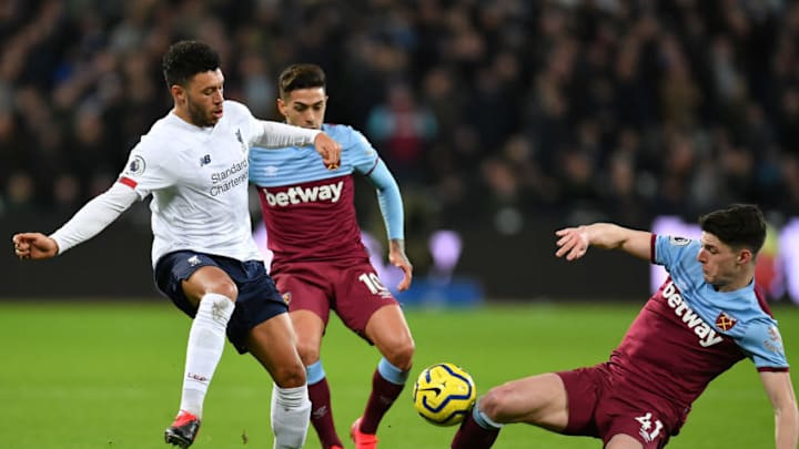 LONDON, ENGLAND - JANUARY 29: Alex Oxlade-Chamberlain of Liverpool is tackled by Declan Rice of West Ham United during the Premier League match between West Ham United and Liverpool FC at London Stadium on January 29, 2020 in London, United Kingdom. (Photo by Justin Setterfield/Getty Images)