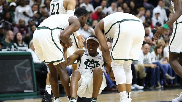 EAST LANSING, MI – NOVEMBER 30: Joshua Langford #1 and Xavier Tilman #23 of the Michigan State Spartans helps Cassius Winston #5 of the Michigan State Spartans off the floor during the game against the Notre Dame Fighting Irish at Breslin Center on November 30, 2017 in East Lansing, Michigan. (Photo by Rey Del Rio/Getty Images)