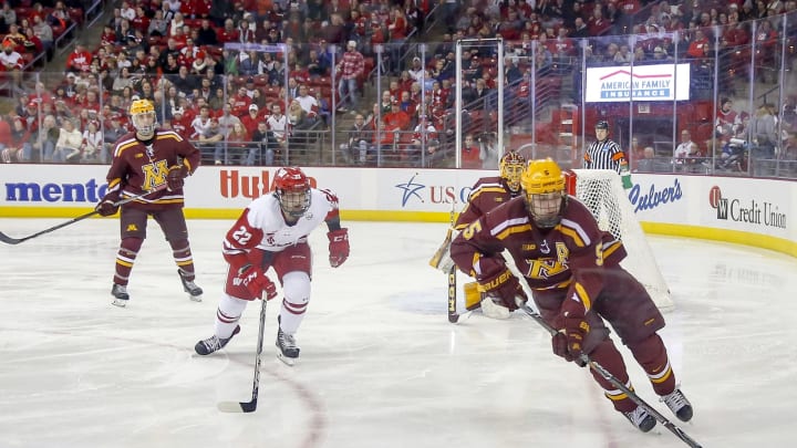 MADISON, WI – FEBRUARY 10: Minnesota defense Ryan Lindgren (5) tries to clear the puck while Wisconsin left wing Max Zimmer (22) skates in during a college hockey match between the University of Wisconsin Badgers and the University of Minnesota Golden Gophers on February 10, 2018 at the Kohl Center in Madison, WI. (Photo by Lawrence Iles/Icon Sportswire via Getty Images)