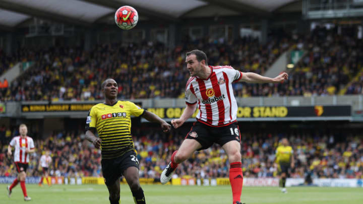 WATFORD, ENGLAND - MAY 15: John O'Shea of Sunderland clears the ball from Odion Ighalo of Watford during the Barclays Premier League match between Watford and Sunderland at Vicarage Road on May 15, 2016 in Watford, England.