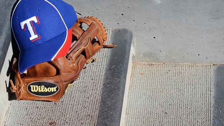 Mar 6, 2012; Salt River Pima-Maricopa, AZ, USA; A detailed view of a Texas Rangers hat and glove during a game against the Arizona Diamondbacks at Salt River Fields at Talking Stick. Mandatory Credit: Jake Roth-USA TODAY Sports