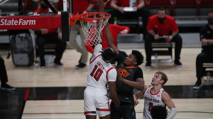 Jan 2, 2021; Lubbock, Texas, USA; Texas Tech Red Raiders forward Tyreek Smith (10) blocks a shot by Oklahoma State Cowboys forward Matthew-Alexander Moncrieffe (12) in the first half at United Supermarkets Arena. Mandatory Credit: Michael C. Johnson-USA TODAY Sports