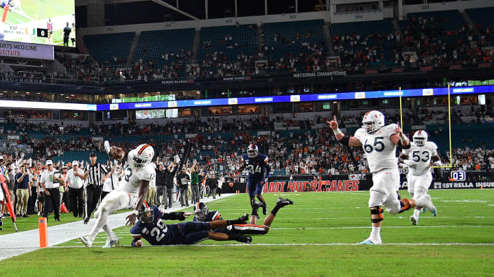 MIAMI, FLORIDA – OCTOBER 11: DeeJay Dallas #13 of the Miami Hurricanes runs for touchdown against the Virginia Cavaliers in the first half at Hard Rock Stadium on October 11, 2019 in Miami, Florida. (Photo by Mark Brown/Getty Images)