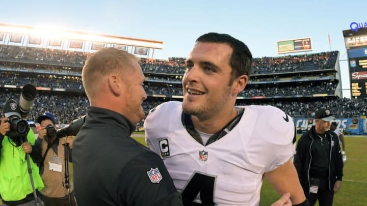 Dec 18, 2016; San Diego, CA, USA; Oakland Raiders quarterback Derek Carr (4) celebrates with quarterbacks coach Todd Downing after a NFL football game against the San Diego Chargers at Qualcomm Stadium. The Raiders defeated the Chargers 19-16. Mandatory Credit: Kirby Lee-USA TODAY Sports