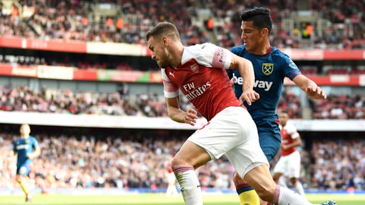 LONDON, ENGLAND - AUGUST 25: Aaron Ramsey of Arsenal is challenged by Lucas Perez of West Ham United during the Premier League match between Arsenal FC and West Ham United at Emirates Stadium on August 25, 2018 in London, United Kingdom. (Photo by Clive Mason/Getty Images)