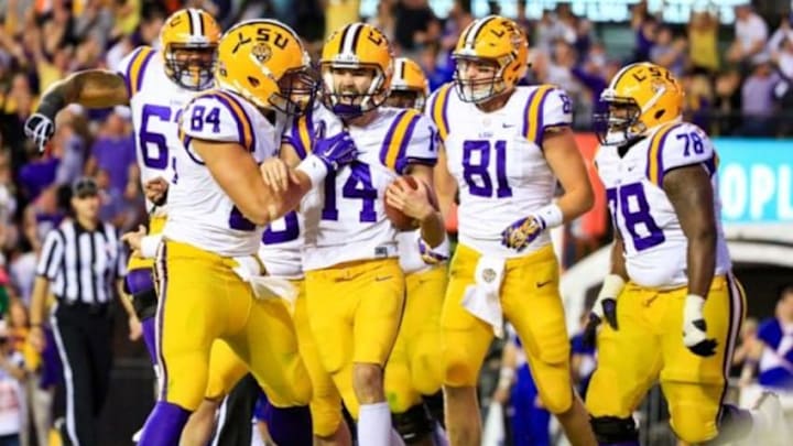Oct 17, 2015; Baton Rouge, LA, USA; LSU Tigers place kicker Trent Domingue (14) celebrates with teammates after scoring a touchdown on a fake field goal against the Florida Gators during the fourth quarter of a game at Tiger Stadium. LSU defeated Florida 35-28. Mandatory Credit: Derick E. Hingle-USA TODAY Sports