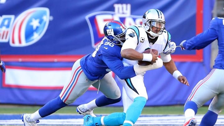 Dec 20, 2015; East Rutherford, NJ, USA; Carolina Panthers quarterback Cam Newton (1) is sacked by New York Giants defensive end Jason Pierre-Paul (90) during the second quarter at MetLife Stadium. Mandatory Credit: Brad Penner-USA TODAY Sports