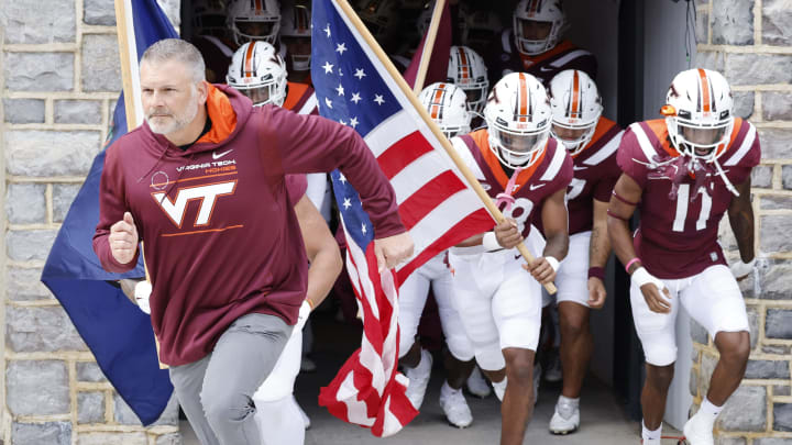 Oct 16, 2021; Blacksburg, Virginia, USA; Virginia Tech Hokies head coach Justin Fuente (left) leads his team from the locker room before the game against the Pittsburgh Panthers at Lane Stadium. Mandatory Credit: Reinhold Matay-USA TODAY Sports