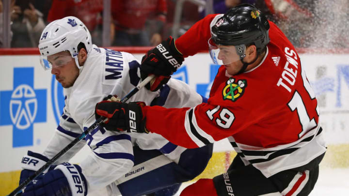 NHL DFS: CHICAGO, IL - OCTOBER 07: Jonathan Toews #19 of the Chicago Blackhawks battles with Auston Matthews #34 of the Toronto Maple Leafs during the regular season opening home game at the United Center on October 7, 2018 in Chicago, Illinois. The Maple Leafs defeated the Blackhawks 7-6 in overtime. (Photo by Jonathan Daniel/Getty Images)
