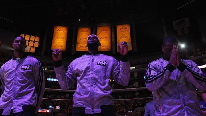 Chris Bosh #1, Lebron James #6 and Dwyane Wade #3 of the Miami Heat stand during the national anthem before the game (Photo by Lisa Blumenfeld/Getty Images)