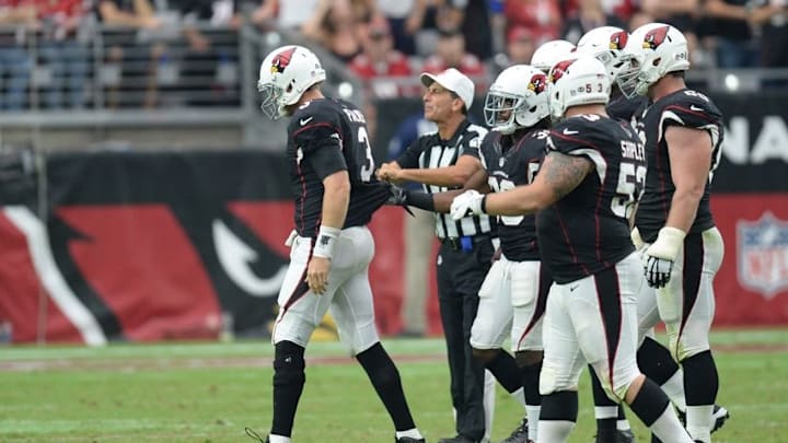 Oct 2, 2016; Glendale, AZ, USA; Arizona Cardinals quarterback Carson Palmer (3) is helped off the ground by teammates after being injured against the Los Angeles Rams during the second half at University of Phoenix Stadium. The Rams won 17-13. Mandatory Credit: Joe Camporeale-USA TODAY Sports