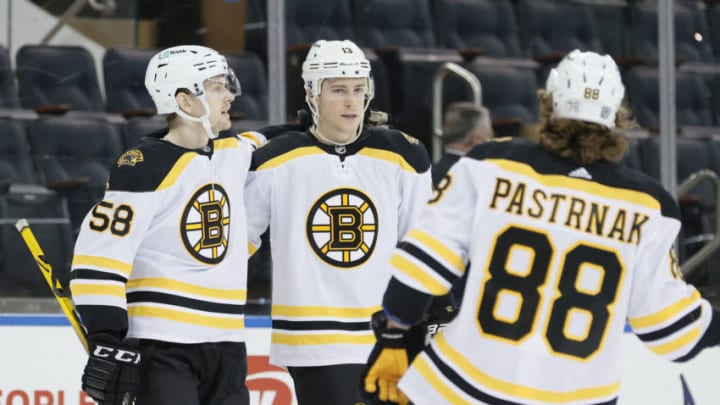 NEW YORK, NEW YORK - FEBRUARY 28: David Pastrnak #88, Charlie Coyle #13, and Urho Vaakanainen #58 of the Boston Bruins celebrate Coyle's goal during the first period against the New York Rangers at Madison Square Garden on February 28, 2021 in New York City. (Photo by Sarah Stier/Getty Images)