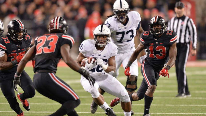 COLUMBUS, OH – OCTOBER 17: Saquon Barkley #26 of the Penn State Nittany Lions looks for running room in the second quarter as Tyvis Powell #23 of the Ohio State Buckeyes and Eli Apple #13 of the Ohio State Buckeyes close in to defend at Ohio Stadium on October 17, 2015 in Columbus, Ohio. Ohio State defeated Penn State 38-10. (Photo by Jamie Sabau/Getty Images)