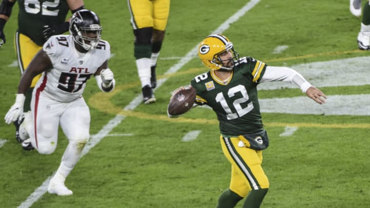 Oct 5, 2020; Green Bay, Wisconsin, USA; Green Bay Packers quarterback Aaron Rodgers (12) throws a pass against the Atlanta Falcons in the second quarter at Lambeau Field. Mandatory Credit: Benny Sieu-USA TODAY Sports