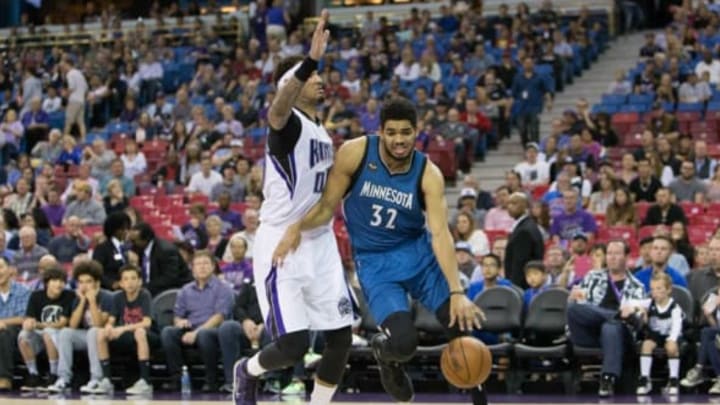 Apr 7, 2016; Sacramento, CA, USA; Minnesota Timberwolves center Karl-Anthony Towns (32) dribbles the basketball against Sacramento Kings center Willie Cauley-Stein (00) in the first quarter at Sleep Train Arena. Mandatory Credit: Neville E. Guard-USA TODAY Sports