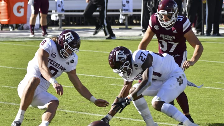 Oct 17, 2020; Starkville, Mississippi, USA; Texas A&M Aggies defensive lineman DeMarvin Leal (8) and defensive back Antonio Johnson (27) attempt to recover a blocked punt against Mississippi State Bulldogs punter Tucker Day (37) during the second quarter at Davis Wade Stadium at Scott Field. Mandatory Credit: Matt Bush-USA TODAY Sports