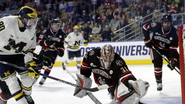 WORCESTER, MA - MARCH 24: Northeastern goalie Cayden Primeau (31) makes a glove save on Michigan Wolverines forward Dexter Dancs (90) during an NCAA Northeast Regional semifinal between the Michigan Wolverines and the Northeastern Huskies on March 24, 2018, at DCU Center in Worcester, Massachusetts. The Wolverines defeated the Huskies 3-2. (Photo by Fred Kfoury III/Icon Sportswire via Getty Images)