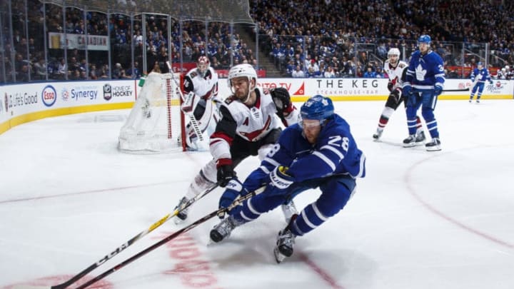 TORONTO, ON - JANUARY 20: Connor Brown #28 of the Toronto Maple Leafs battles with the puck with Niklas Hjalmarsson #4 of the Arizona Coyotes during the third period at the Scotiabank Arena on January 20, 2019 in Toronto, Ontario, Canada. (Photo by Mark Blinch/NHLI via Getty Images)