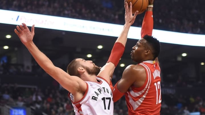 Mar 6, 2016; Toronto, Ontario, CAN; Houston Rockets center Dwight Howard (7) drives to the basket against Toronto Raptors player Jonas Valanciunas in the first quarter at Air Canada Centre. Mandatory Credit: Dan Hamilton-USA TODAY Sports