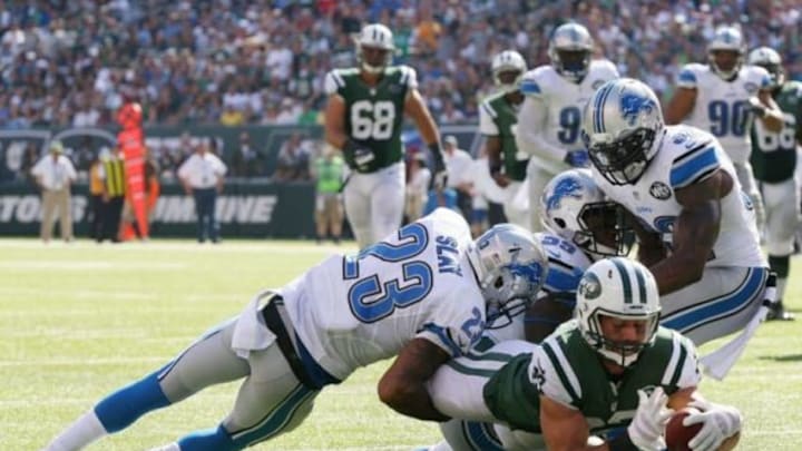 Sep 28, 2014; East Rutherford, NJ, USA; New York Jets wide receiver Eric Decker (87) scores a touchdown as Detroit Lions cornerback Darius Slay (23), middle linebacker Stephen Tulloch (55), and strong safety James Ihedigbo (32) defend in the third quarter at MetLife Stadium. Mandatory Credit: Noah K. Murray-USA TODAY Sports