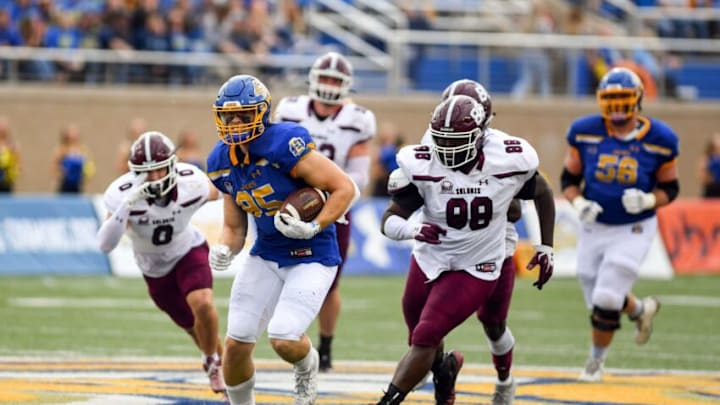 South Dakota State's Tucker Kraft runs from a host of Southern Illinois players while carrying the ball on Saturday, October 9, 2021, at Dana J. Dykhouse Stadium in Brookings.Sdsu Vs Si 023