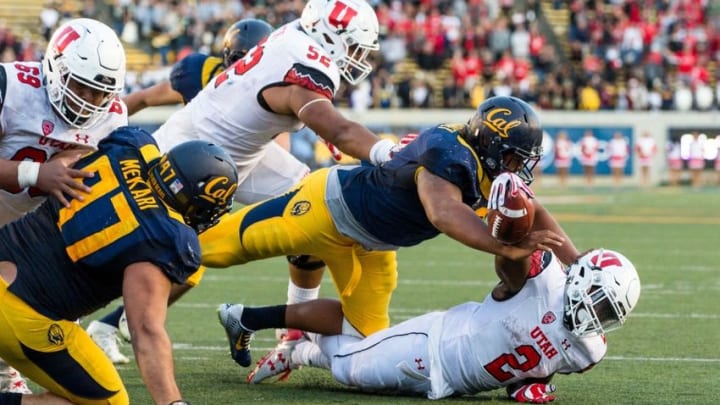 Oct 1, 2016; Berkeley, CA, USA; California Golden Bears defensive tackle James Looney (9) tackles Utah Utes running back Zack Moss (2) in the last play of the game in the fourth quarter at Memorial Stadium. Cal won 28-23. Mandatory Credit: John Hefti-USA TODAY Sports