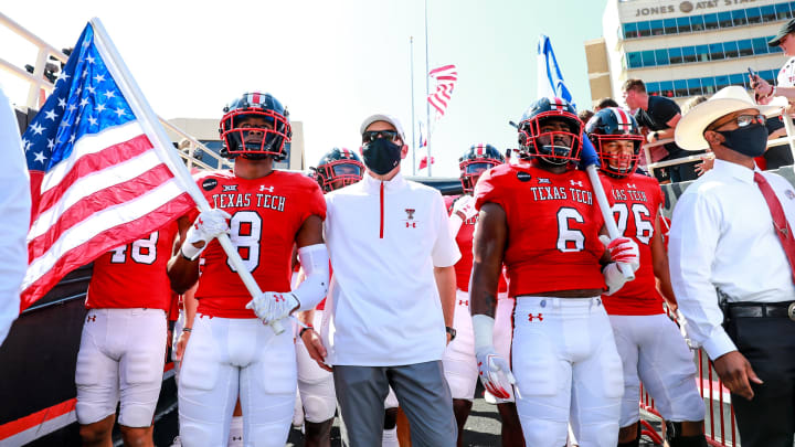 LUBBOCK, TEXAS – SEPTEMBER 26: Cornerback Zech McPhearson #8, head coach Matt Wells, and linebacker Riko Jeffers #6 of the Texas Tech Red Raiders prepare to lead the Red Raiders onto the field before the college football game against the Texas Longhorns on September 26, 2020 at Jones AT&T Stadium in Lubbock, Texas. (Photo by John E. Moore III/Getty Images)