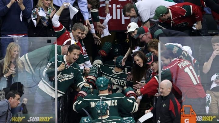Apr 21, 2014; Saint Paul, MN, USA; Fans congratulate the Minnesota Wild following the game against the Colorado Avalanche in game three of the first round of the 2014 Stanley Cup Playoffs at Xcel Energy Center. The Wild defeated the Avalanche 1-0 in overtime. Mandatory Credit: Brace Hemmelgarn-USA TODAY Sports