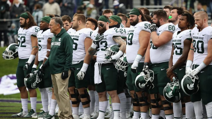 EVANSTON, IL – OCTOBER 28: Head coach Mark Dantonio of the Michigan State Spartans stands with his team before a agem against the Northwestern Wildcats at Ryan Field on October 28, 2017 in Evanston, Illinois. Northwestern defeated Michigan State 39-31 in triple overtime. (Photo by Jonathan Daniel/Getty Images)