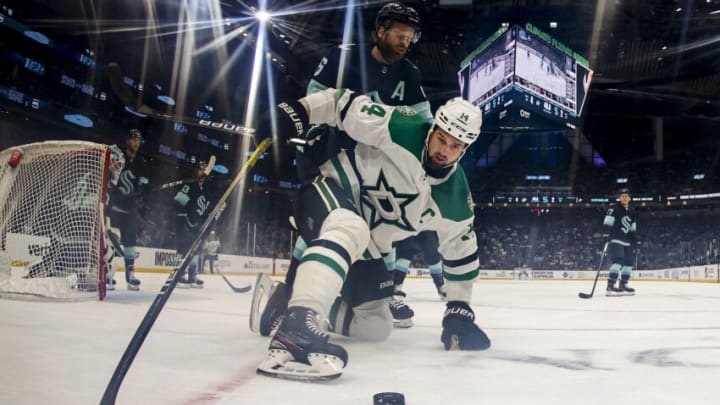 SEATTLE, WASHINGTON - MARCH 13: Jamie Benn #14 of the Dallas Stars controls the puck against Adam Larsson #6 of the Seattle Kraken during the second period at Climate Pledge Arena on March 13, 2023 in Seattle, Washington. (Photo by Steph Chambers/Getty Images)