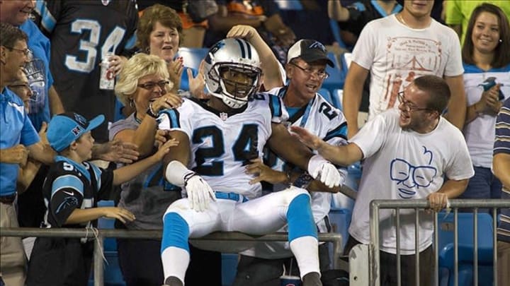 Aug 9, 2013; Charlotte, NC, USA; Carolina Panthers cornerback Josh Norman (24) jumps up in the stands to celebrate after returning an interception for a touchdown during the second half against the Chicago Bears. The Panthers defeated the Bears 24-17. Mandatory Credit: Jeremy Brevard-USA TODAY Sports