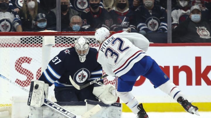 Mar 1, 2022; Winnipeg, Manitoba, CAN; Winnipeg Jets goalie Connor Hellebuyck (37) makes a save on a penalty shot by Montreal Canadiens forward Rem Pitlick (32) during the second period at Canada Life Centre. Mandatory Credit: Terrence Lee-USA TODAY Sports