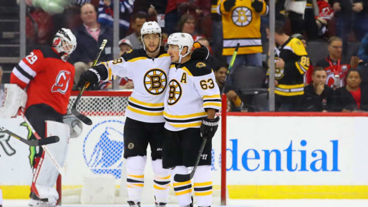 NEWARK, NJ - NOVEMBER 19: Boston Bruins right wing David Pastrnak (88) celebrates with teammate Boston Bruins center Brad Marchand (63) after scoring during the National Hockey League game between the New Jersey Devils and the Boston Bruins on November 19, 2019 at the Prudential Center in Newark, NJ. (Photo by Rich Graessle/Icon Sportswire via Getty Images)