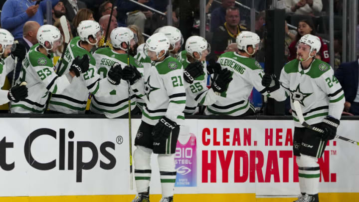May 19, 2023; Las Vegas, Nevada, USA; Dallas Stars left wing Jason Robertson (21) and center Roope Hintz (24) celebrates with the team bench after Robertson scores a goal against the Vegas Golden Knights during the first period in game one of the Western Conference Finals of the 2023 Stanley Cup Playoffs at T-Mobile Arena. Mandatory Credit: Stephen R. Sylvanie-USA TODAY Sports