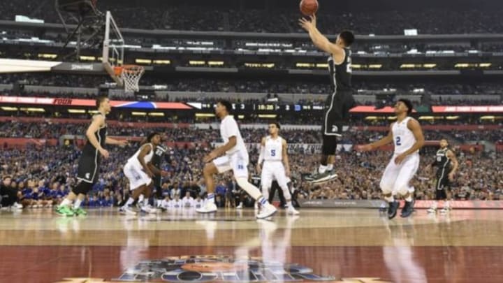 Apr 4, 2015; Indianapolis, IN, USA; Michigan State Spartans guard Travis Trice (20) shoots a three-point shot over Duke Blue Devils guard Quinn Cook (2) in the first half of the 2015 NCAA Men Apr 4, 2015; Indianapolis, IN, USA; Michigan State Spartans guard Travis Trice (20) shoots a three-point shot over Duke Blue Devils guard Quinn Cook (2) in the first half of the 2015 NCAA Men