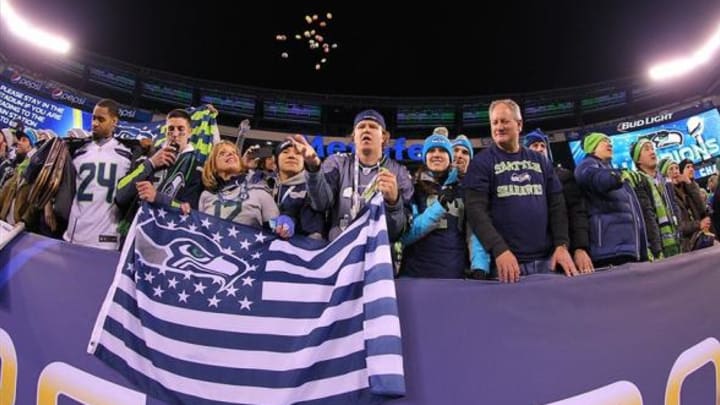 Feb 2, 2014; East Rutherford, NJ, USA; Seattle Seahawks fans celebrates after beating the Denver Broncos 43-8 in Super Bowl XLVIII at MetLife Stadium. Mandatory Credit: Brad Penner-USA TODAY Sports