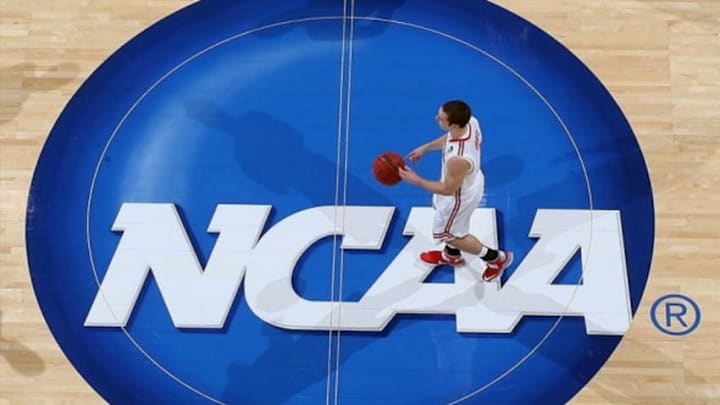 Mar 24, 2013; Dayton, OH, USA; Ohio State Buckeyes guard Aaron Craft (4) brings the ball up court across the NCAA logo in a game against the Iowa State Cyclones during the third round of the 2013 NCAA tournament at University of Dayton Arena. Ohio State defeats Iowa State 78-75. Mandatory Credit: Brian Spurlock-USA TODAY Sports
