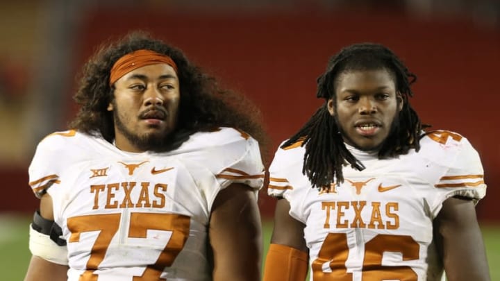 Oct 31, 2015; Ames, IA, USA; Texas Longhorns teammates offensive lineman Patrick Vahe (77) and linebacker Malik Jefferson (46) walk off the field after losing to the Iowa State Cyclones at Jack Trice Stadium. The Cyclones beat the Longhorns 24-0. Mandatory Credit: Reese Strickland-USA TODAY Sports