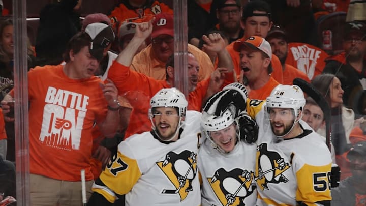 PHILADELPHIA, PA - APRIL 22: Jake Guentzel #59 of the Pittsburgh Penguins (c) celebrates his goal at 12:58 of the third period against the Philadelphia Flyers and is joined by Sidney Crosby #87 (l) and Kris Letang #58 (r) in Game Six of the Eastern Conference First Round during the 2018 NHL Stanley Cup Playoffs at the Wells Fargo Center on April 22, 2018 in Philadelphia, Pennsylvania. The Penguins defeated the Flyers 8-5 to win the series 4-2. (Photo by Bruce Bennett/Getty Images)