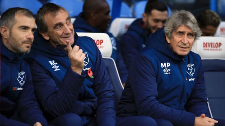 HUDDERSFIELD, ENGLAND - NOVEMBER 10: Manuel Pellegrini (R) manager of West Ham United, assistant Ruben Cousillas (C) and 2nd assistant coach Enzo Maresca during the Premier League match between Huddersfield Town and West Ham United at John Smith's Stadium on November 10, 2018 in Huddersfield, United Kingdom. (Photo by Marc Atkins/Getty Images)