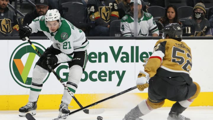 LAS VEGAS, NEVADA - DECEMBER 08: Jason Robertson #21 of the Dallas Stars controls the puck against Dylan Coghlan #52 of the Vegas Golden Knights in the third period of their game at T-Mobile Arena on December 8, 2021 in Las Vegas, Nevada. The Golden Knights defeated the Stars 5-4. (Photo by Ethan Miller/Getty Images)